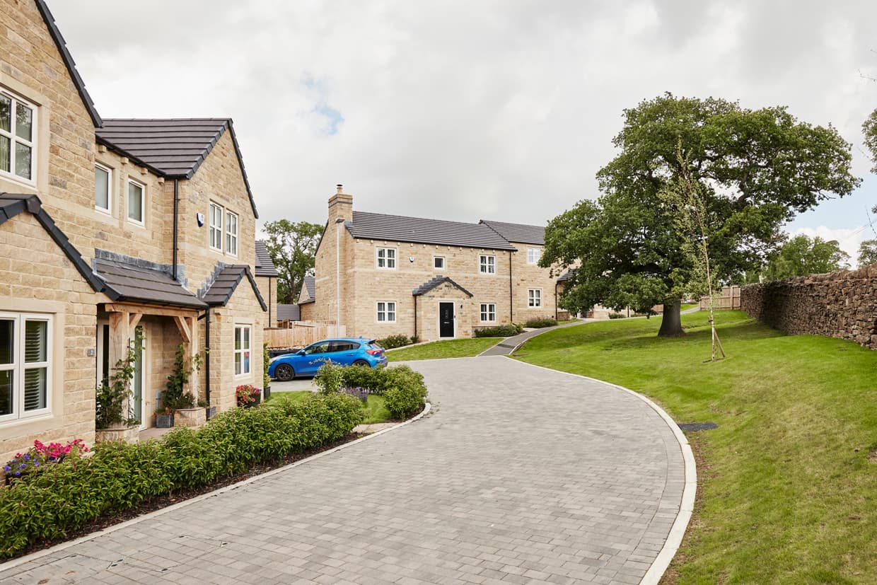 A street of completed natural stone homes at Bolton Gardens, Silsden