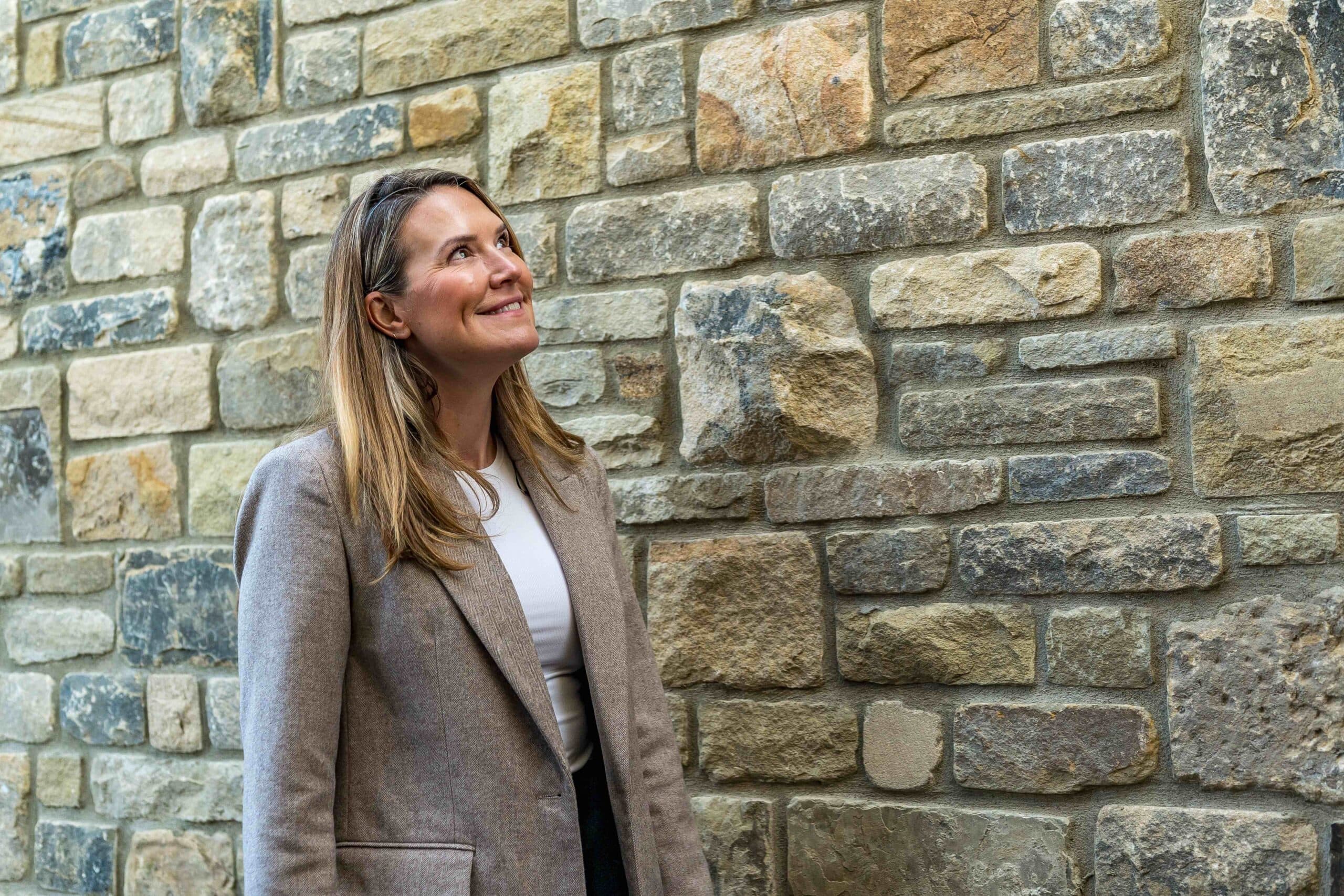 Managing Director , Sarah at Pendle Farm in front of a random stone wall